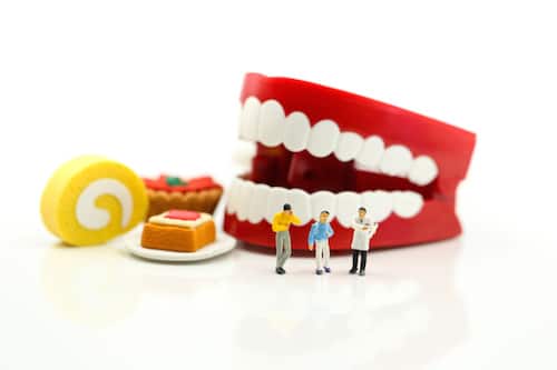 Miniature People : Doctor Dentist Speaks About Student And Children With Desserts,fun Eating And Healthcare Concept.